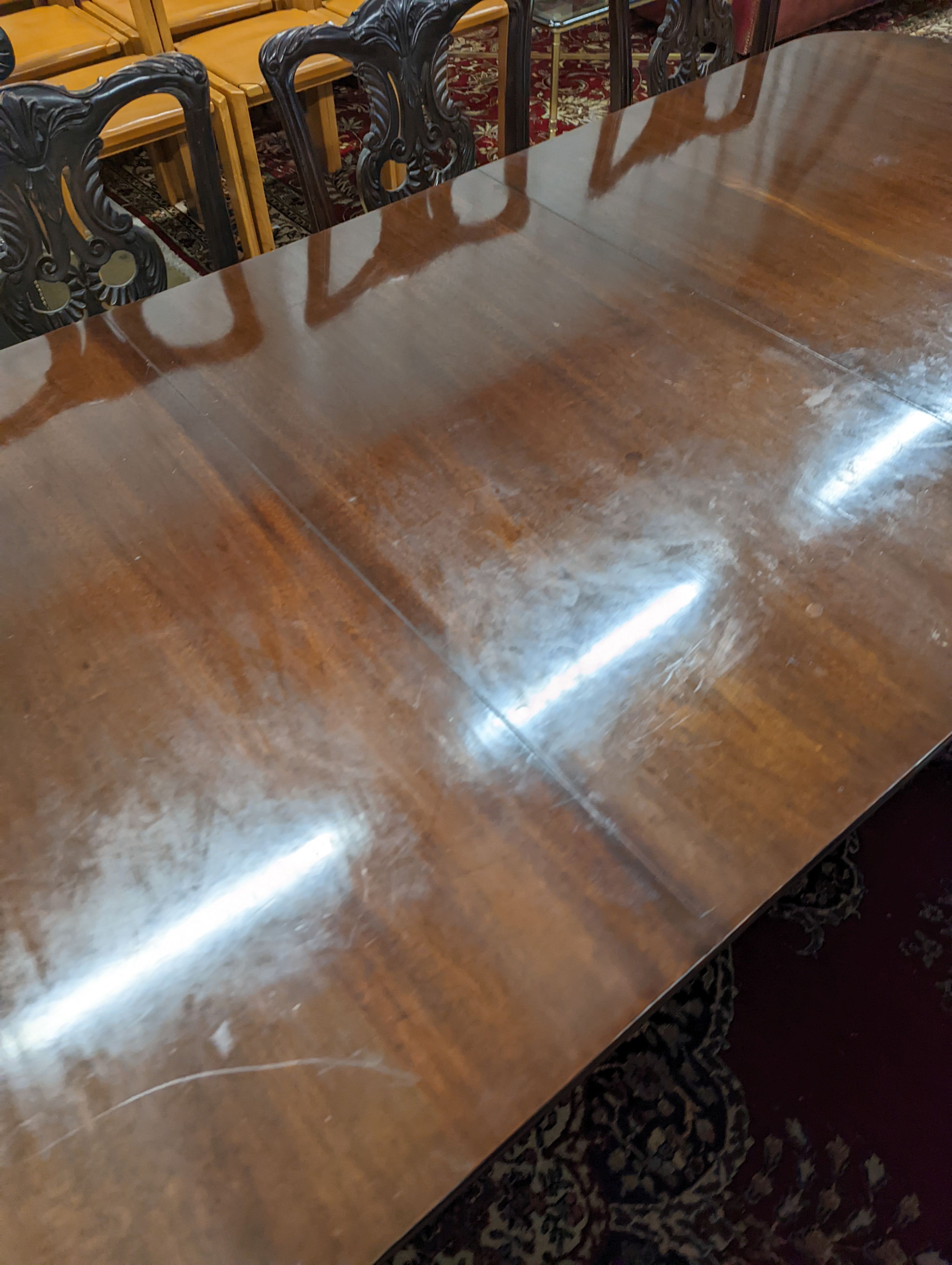 A reproduction George III style rectangular mahogany extending dining table, 241cm extended, one spare leaf, depth 104cm, height 74cm